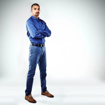 I dont want or wait for change. a young businessman posing against a grey background