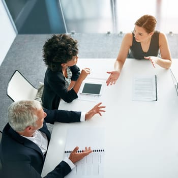 People in business meeting, collaboration and planning top view, project management and paperwork. Teamwork, man and women in strategy discussion with market research and mission in conference room.