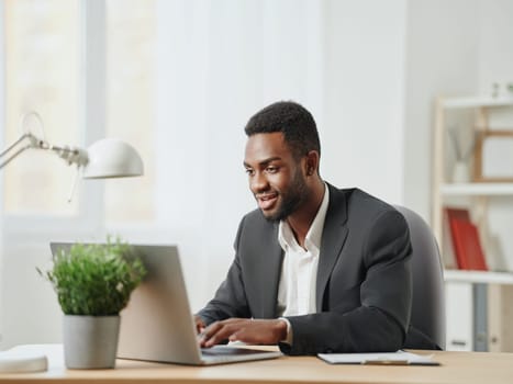 man computer job american african education smiling laptop freelancer looking office home copy student space technology freelance business male indoor online chat using