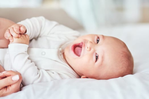 Laugh, portrait and a baby on the bed with mother for play, bonding and wake up in the morning. Smile, house and a little newborn child in the bedroom for happiness, care and together with mom.
