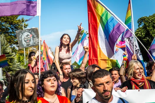 Reporting by journalists on the LGBT pride event held in Sanremo, where attendees enjoy themselves and march in the streets.