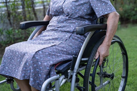 Caregiver help and care Asian senior woman patient sitting on wheelchair at nursing hospital ward, healthy strong medical concept.