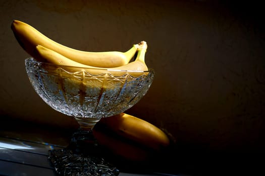 a long curved fruit which grows in clusters and has soft pulpy flesh and yellow skin when ripe