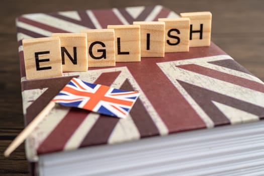 Word English on book with United Kingdom flag, learning English language courses concept.