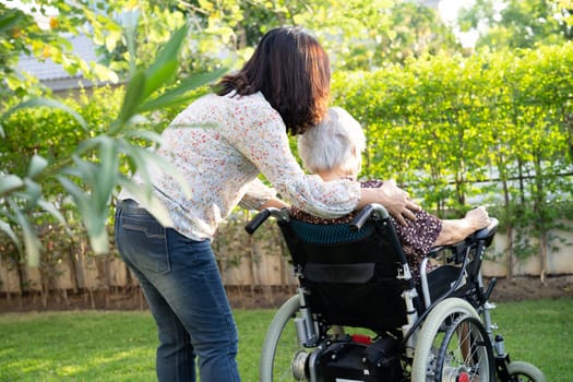 caregiver help and care Asian senior woman patient sitting on wheelchair at nursing hospital ward, healthy strong medical concept.