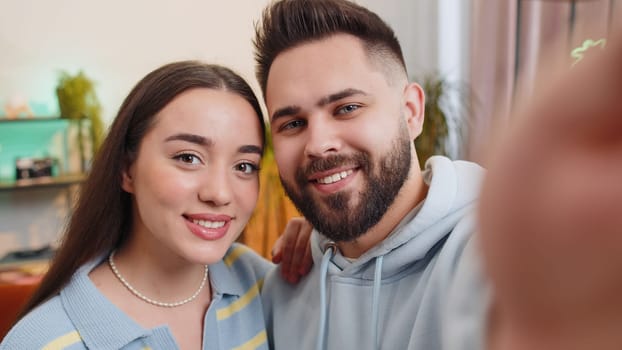 POV of family marriage couple man woman taking selfie vlog social media videoblog, communicating with followers, laughing looking to camera sharing news, call online at home. Husband and wife together