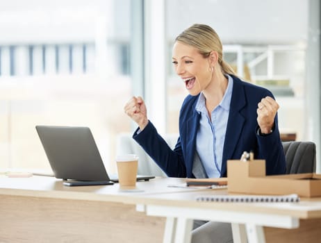 Business, woman and excited at achievement at a desk with success at the office with laptop. Celebrate, female professional and good news at a company with promotion for happiness with a computer