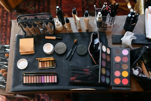 The cosmetics on the table lipstick foundation brush shadow