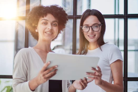 Businesswomen Having Informal Meeting In Modern Office