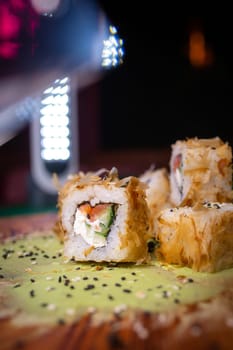 warm rolls on a wooden board with wasabi.