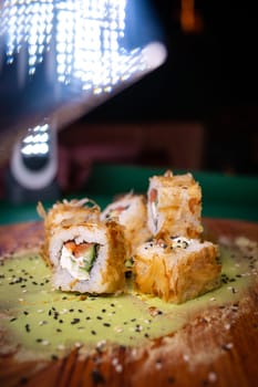 warm rolls on a wooden board with wasabi.