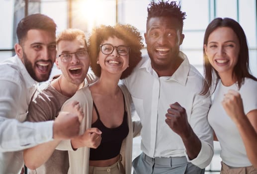 Portrait of successful creative business team looking at camera and smiling. Diverse business people standing together at startup.