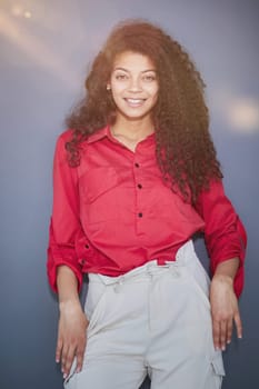 Happy young business woman posing isolated over grey wall background.