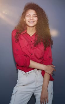 Happy young business woman posing isolated over grey wall background.