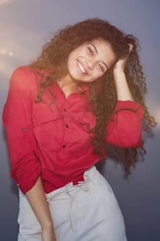 Happy young business woman posing isolated over grey wall background.