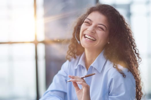 Portrait of an attractive cheerful experienced girl advising clients on customer service in the office