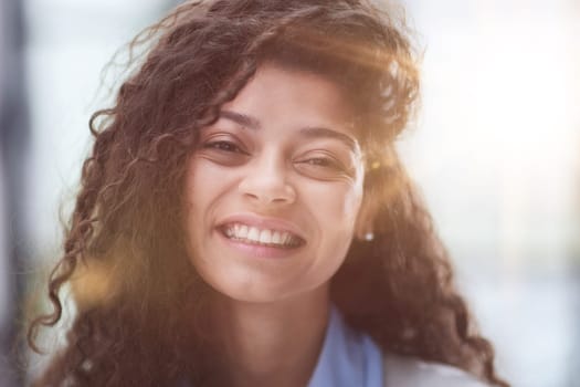 Portrait of young smiling woman looking at camera