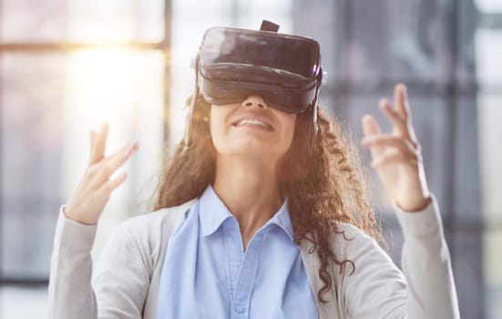 Girl trying to touch objects in virtual reality.