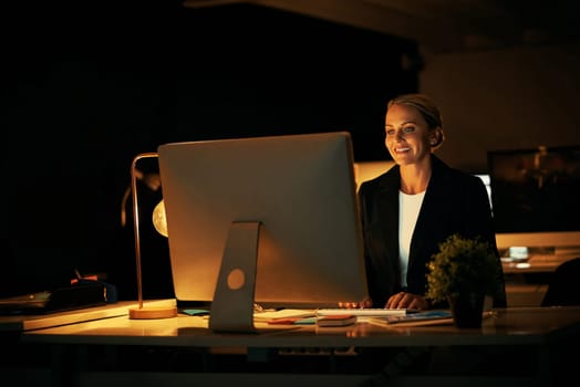 Working late into the night. a mature businesswoman working late at the office