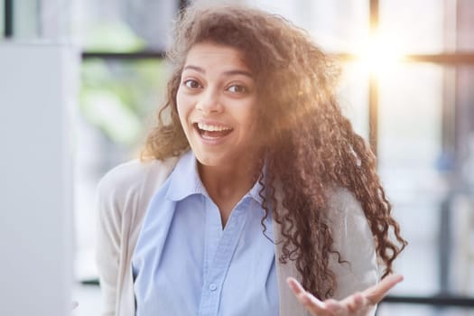 expressive young woman open mouth checking discounts for online shopping sitting at desktop .
