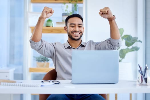 Businessman, laptop and celebrate success or win at desk with fist for bonus deal. Excited Asian man or entrepreneur with tech for profit, competition or online achievement and loan notification.
