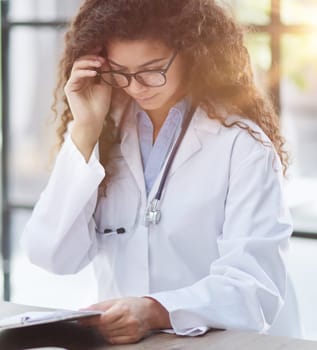 Closeup portrait, woman healthcare professional with stethoscope enjoying reading