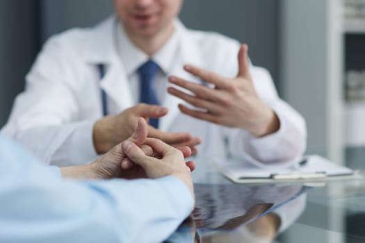 Doctor's Appointment. Unrecognizable Therapist man Discussing Treatment With Her Client Sitting In Modern Clinic Office. Selective Focus, Cropped