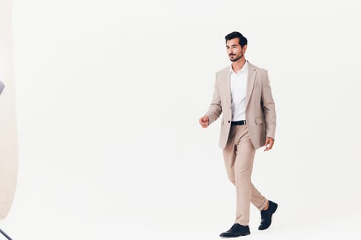 man winner victory cheerful adult beard isolated flying business jacket standing occupation smiling happy jumping running attractive office beige businessman suit white
