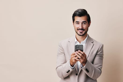 technology man cyberspace person portrait studio suit application mobile app lifestyle happy background hold phone connection business smile smartphone selfies call