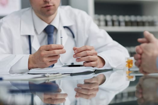 A young man receives information about an electronic cigarette, close-up