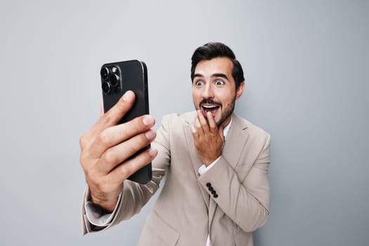 man phone smile mobile studio call internet app suit guy portrait hold business holding isolated happy background trading smartphone gray online