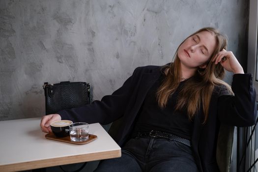 charming confident brunette woman in a cafe with coffee. coffee break. business woman.