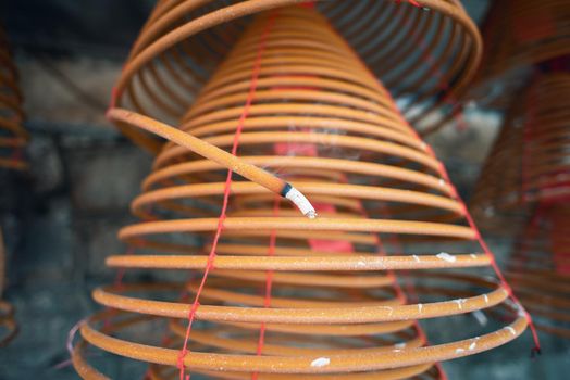 Burned coil swirl incense in Macau (Macao) temple, traditional Chinese cultural customs to worship god, close up, lifestyle.
