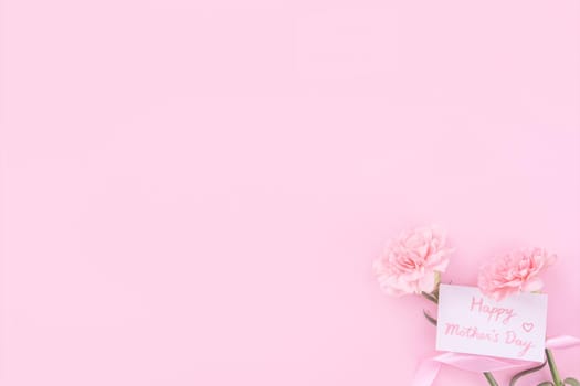 Beautiful, fresh elegant carnation flower bouquet with white greeting thanks gift card isolated on bright pink color background, top view, flat lay concept.