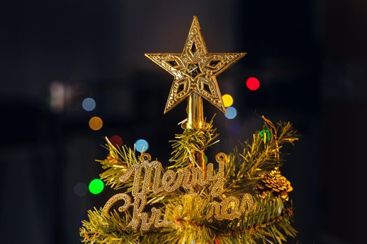 Beautiful Christmas decor concept, bauble hanging on the Christmas tree with sparkling light spot, blurry dark black background, macro detail, close up.