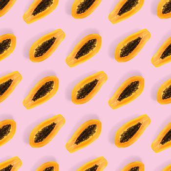 Fresh ripe papaya seamless pattern on pink background. Tropical abstract background. Top view. Creative design, minimal flat lay concept. Trend tropical fruit food background pattern