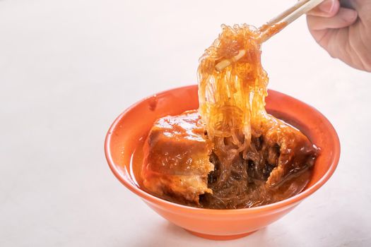 Tamsui agei (age, aburaage), delicious famous street food in Taipei, Taiwan, stuffed with mung bean noodles and chili sauce topping, lifestyle, close up.