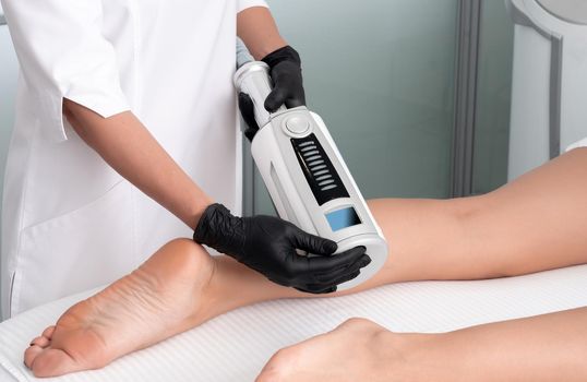 Partial view of cosmetologist in rubber gloves doing endospheres therapy