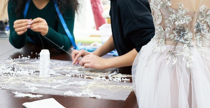 A mannequin with a dress is in the tailor's tailor's shop. Evening, wedding, attire