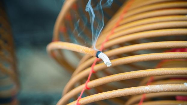 Burned coil swirl incense in Macau (Macao) temple,traditional Chinese cultural customs to worship god,close up,lifestyle.