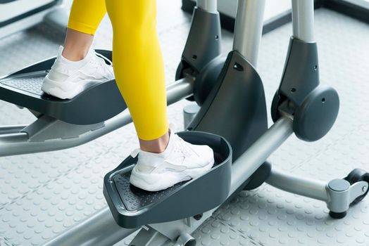 Gym: Woman Working Out On Elliptical Machine