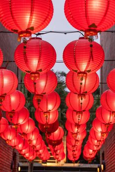 Beautiful round red lantern hanging on old traditional street, concept of Chinese lunar new year festival, close up. The undering word means blessing.