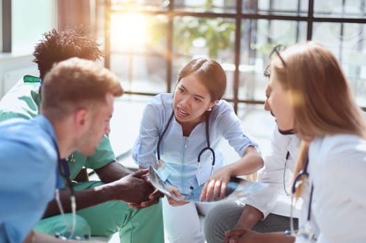 Group of multiethnic doctors looking at x-ray