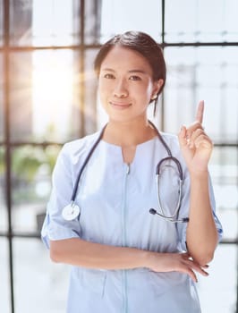 Portrait of asian woman doctor showing thumb up in hospital