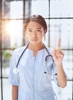 Portrait of asian woman doctor showing thumb up in hospital
