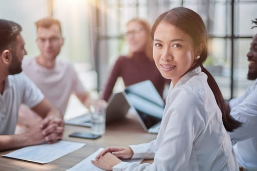 young attractive business lady looking at the camera while sitting at the table