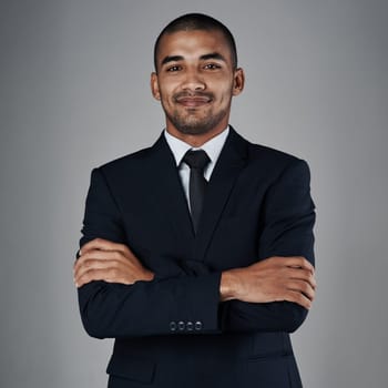 I pride myself on delivering nothing but the best results. Studio portrait of a corporate businessman posing against a grey background