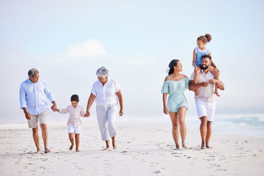 Big family, grandparents walking or kids on beach with young siblings holding hands on holiday together. Dad, mom or children love bonding, smiling or relaxing with senior grandmother or grandfather.