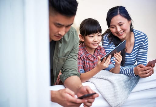 Theyre a family who enjoy the wonders of technology. a family using digital devices at home