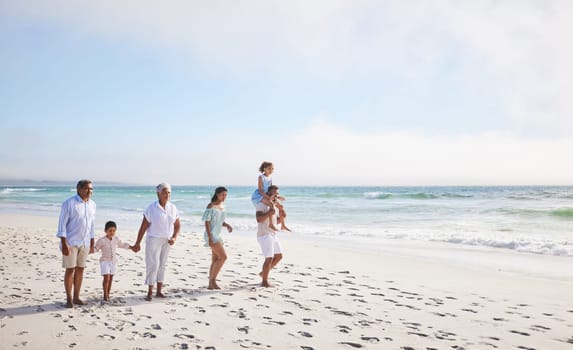 Big family, grandparents walking or children on beach with young siblings holding hands on holiday together. Dad, mom or kids love bonding, smiling or relaxing with senior grandmother or grandfather.